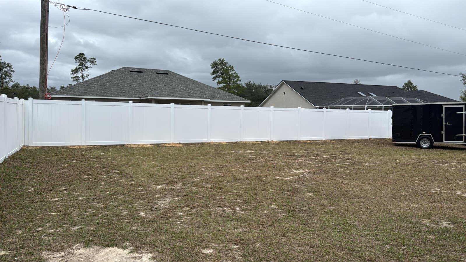 New white vinyl privacy fence installed on a Central Florida property